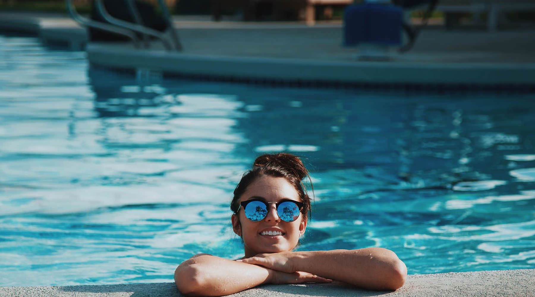 A perfect fit for the whole family woman in a pool with sunglasses on